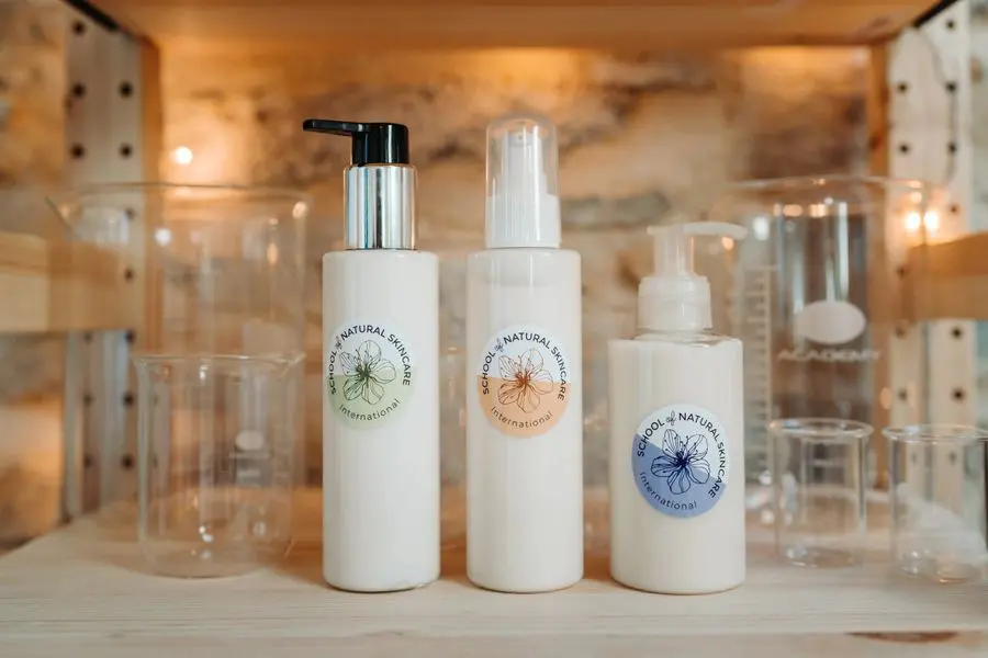 Natural skincare bottles on shelf with glassware